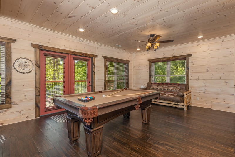 Challenge friends to a game in your private billiards room, where rustic charm meets entertainment beneath soaring woodpaneled ceilings.