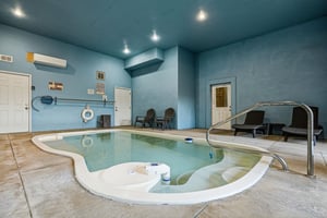 Soak away your cares in the serene indoor pool, where calm blue tones and poolside loungers invite you to float, unwind, and forget the world outside.