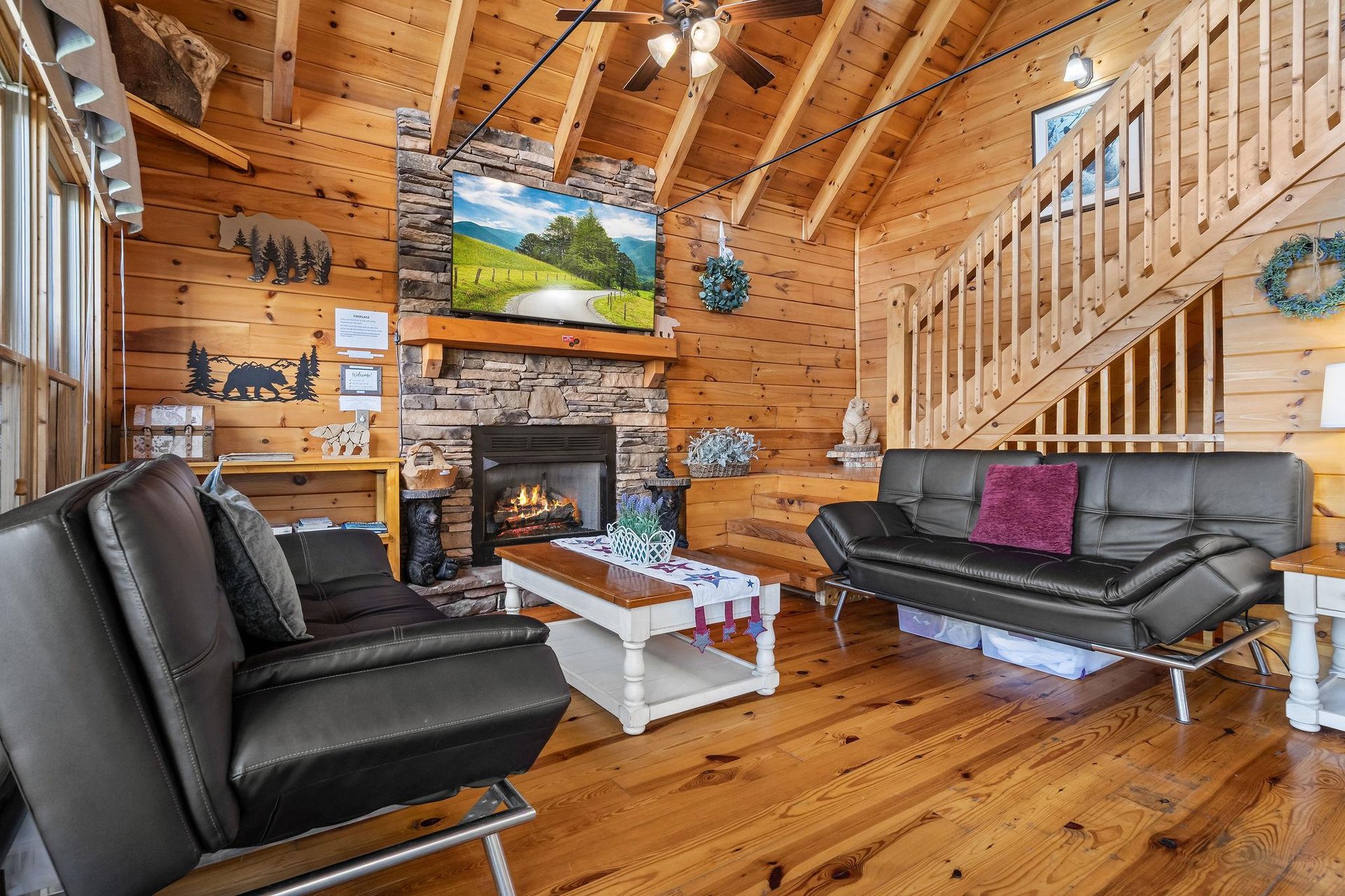 Living room with 2 futons and stone fireplace