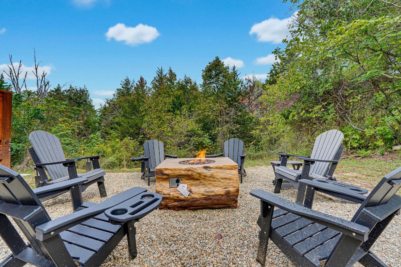 Circle around the fire pit in these comfortable Adirondack chairs, perfect for sharing stories under the open sky with trees all around.