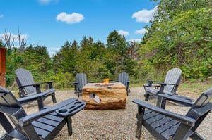 Circle around the fire pit in these comfortable Adirondack chairs, perfect for sharing stories under the open sky with trees all around.
