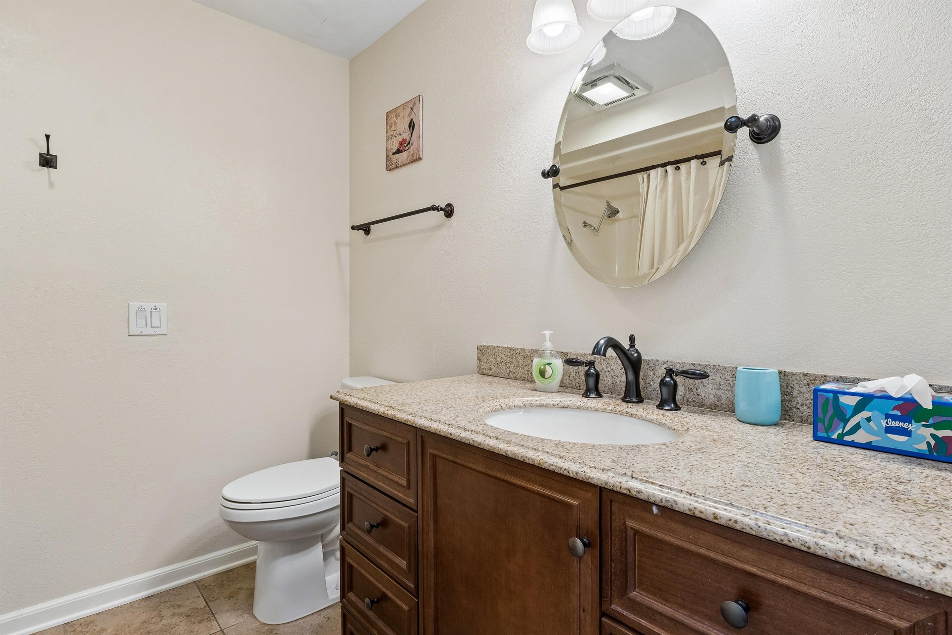 Full bathroom with showertub combo.