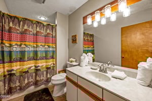 Your stylish bathroom features mountainthemed decor, pristine white linens, and modern fixtures for your comfort.