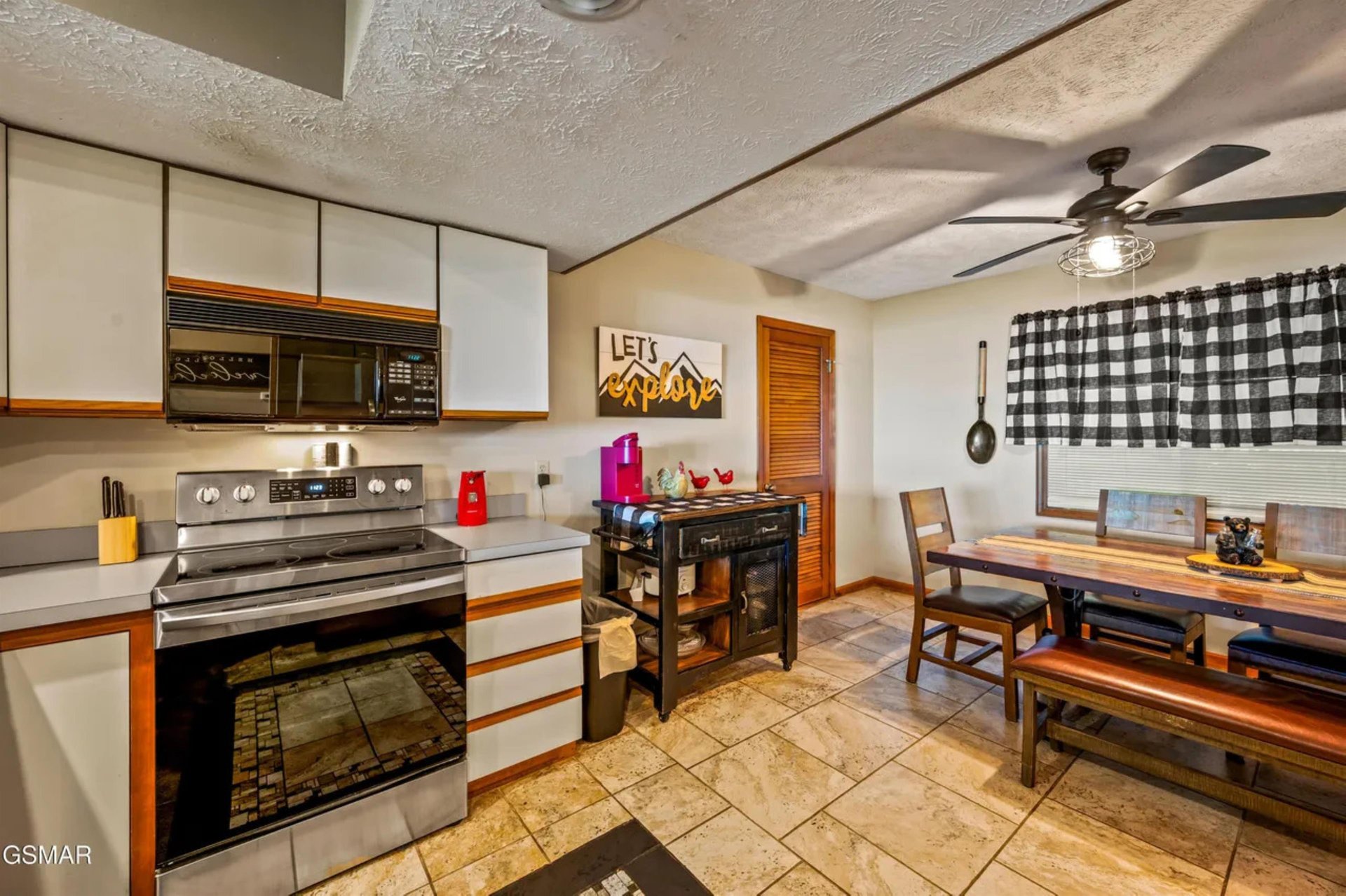 Cook your favorite meals in this wellequipped kitchen with modern appliances and enjoy dining at the rustic wooden table.