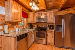 Kitchen with stainless appliances at Cupids Crossing, a 1 bedroom cabin rental located in Pigeon Forge