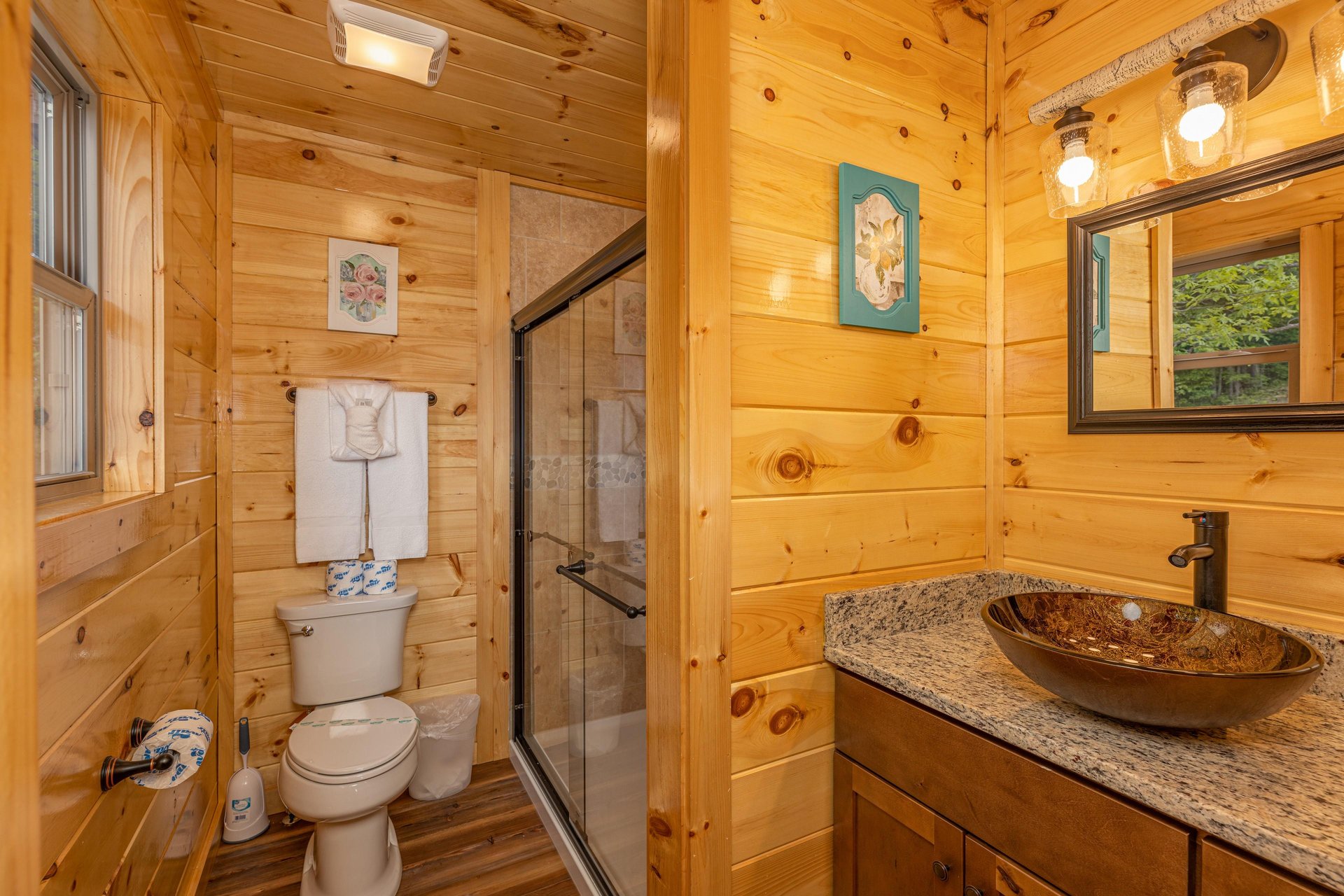 Walk in shower with divider wall to single vanity sink