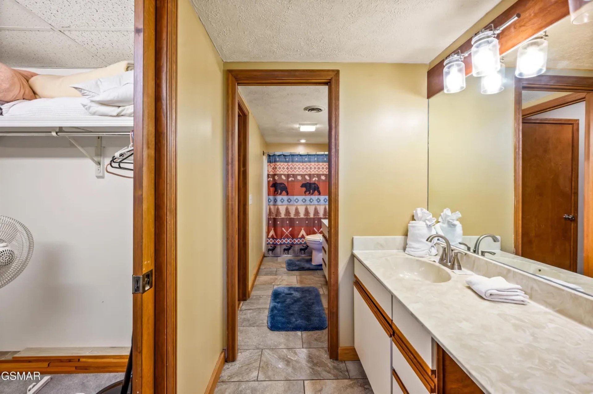 Your spacious bathroom features elegant marble counters, warm wood accents, and thoughtful touches like fresh towels awaiting your arrival.