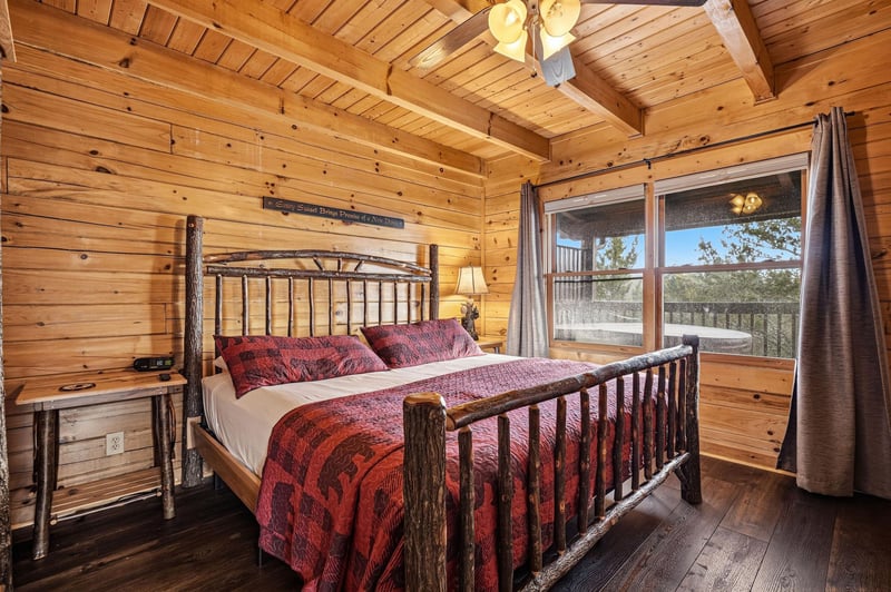 Drift off in your rustic bedrooms handcrafted log bed while natural light streams through windows overlooking peaceful treetops.