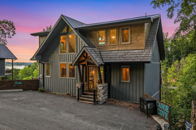 Charming lakeside retreat with modern rustic architecture, nestled among lush greenery and captured during a stunning twilight moment.