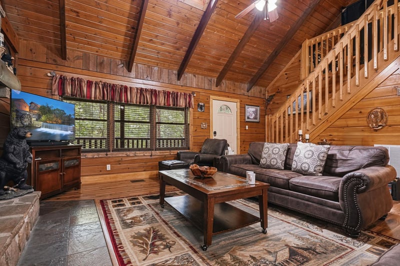 Unwind in your cozy cabin retreat with rustic wood beams, plush leather seating, and warm natural light streaming through. Your perfect mountain escape awaits.