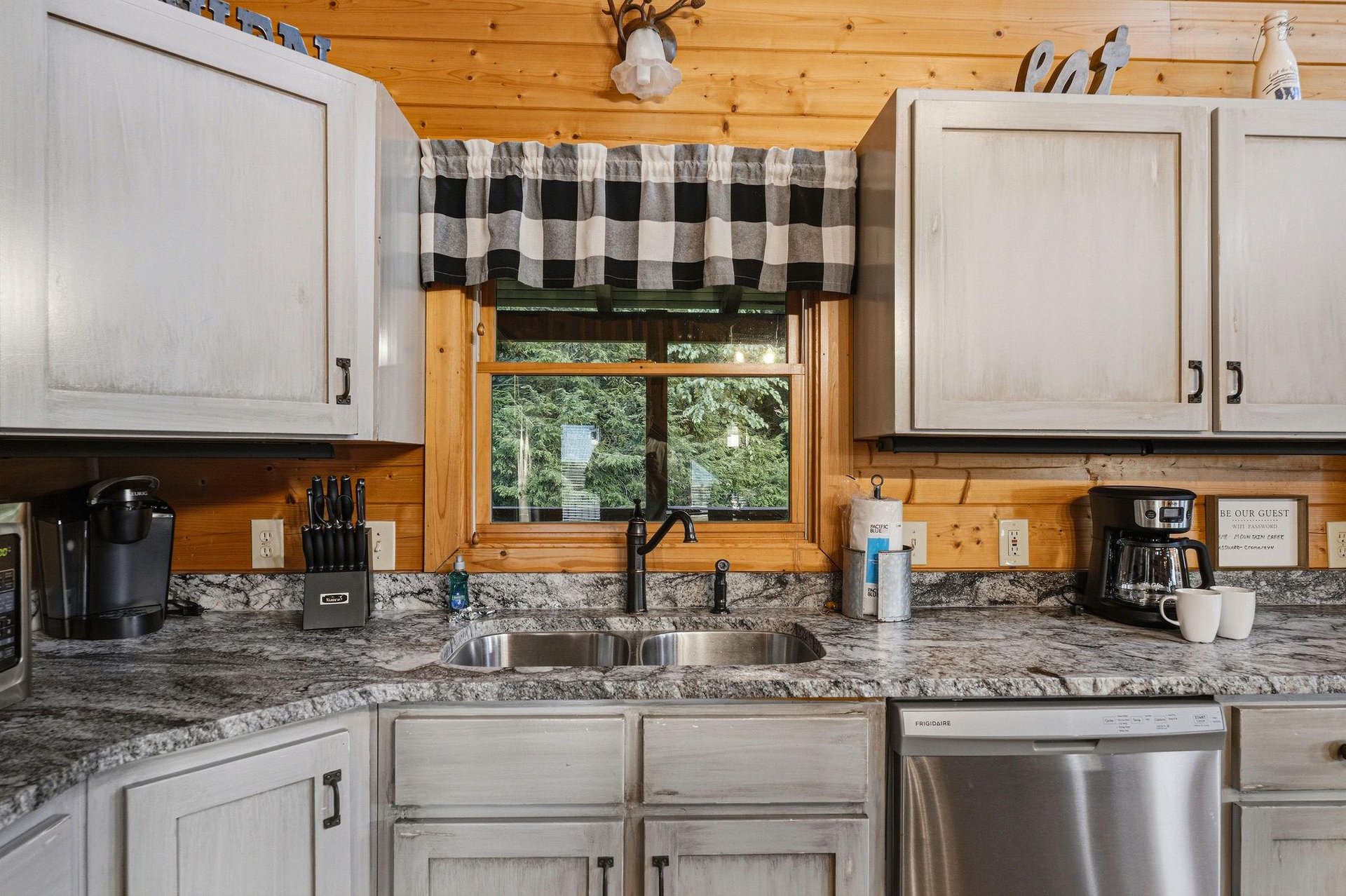 Your fully equipped kitchen features rustic woodpaneled ceilings and granite countertops, with everything you need to prepare your favorite meals. A garden view through the window adds a peaceful tou