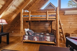 Cozy log cabin bedroom with sturdy bunk beds perfect for family adventures and restful mountain nights.