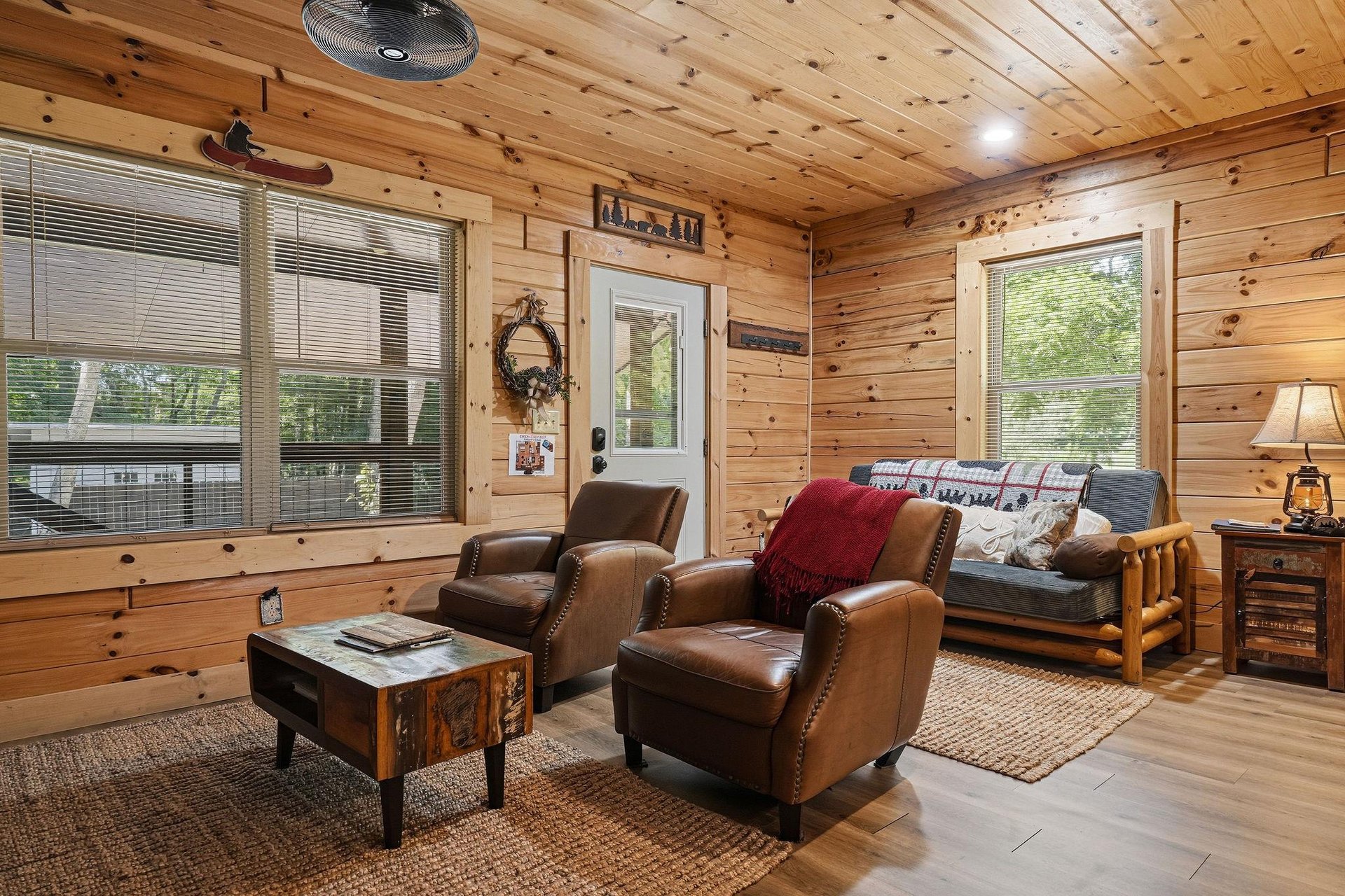 Relax in your cozy living room, where warm knotty pine walls and rustic furnishings create the perfect mountain retreat. Sink into plush leather seating and unwind as natural light fills the space.
