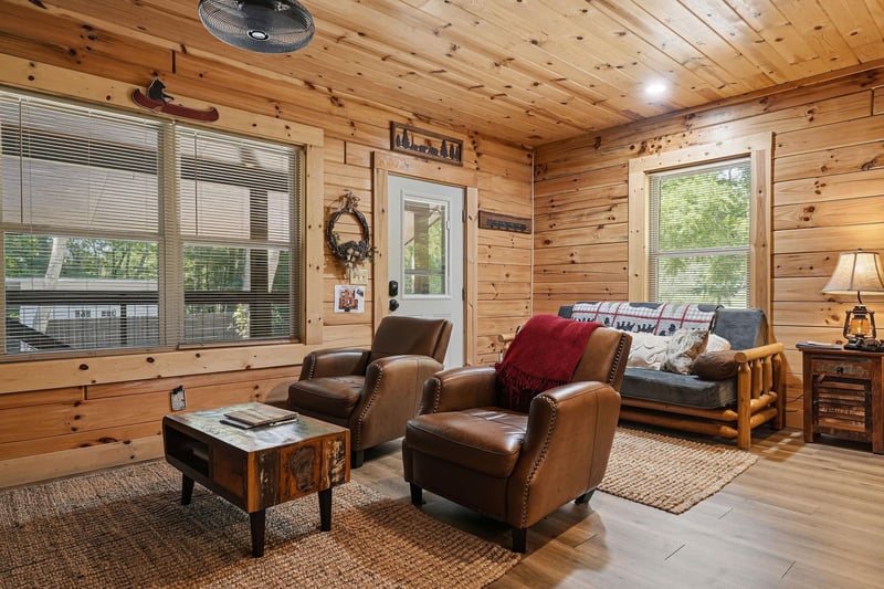 Relax in your cozy living room, where warm knotty pine walls and rustic furnishings create the perfect mountain retreat. Sink into plush leather seating and unwind as natural light fills the space.