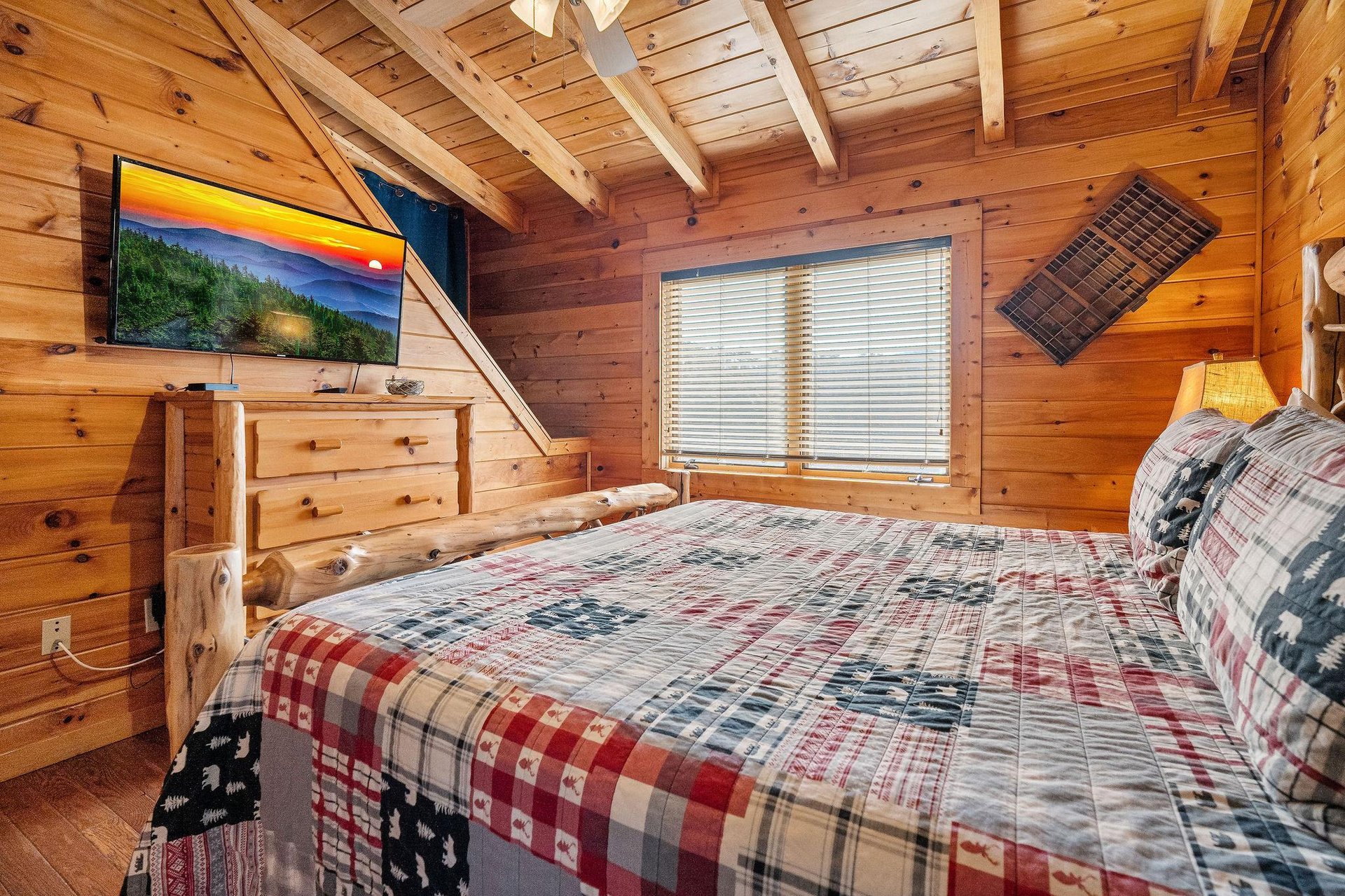 Bedroom with a wood bed at Mountain Mama, a 3 bedroom cabin rental located in Pigeon Forge