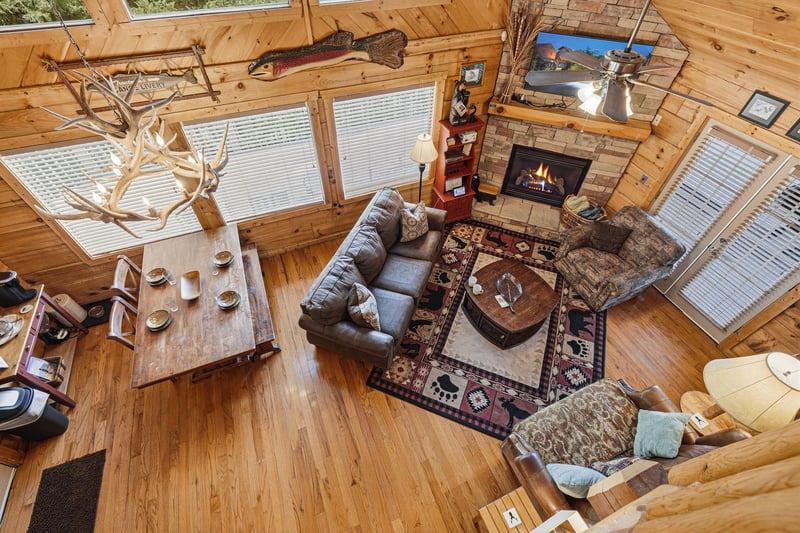 Gather around the warm fireplace in your cozy, lightfilled living area. Rustic wood beams and charming cabin décor create the perfect retreat after a day of adventure.