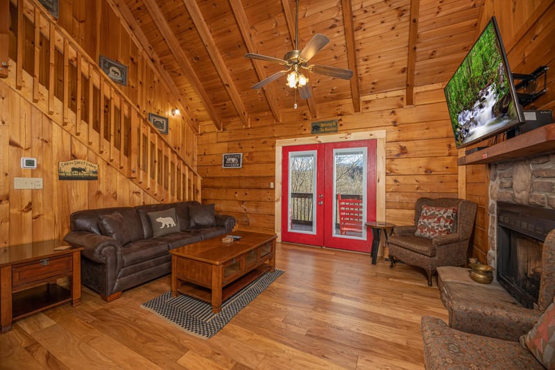 Living room with red doors to deck