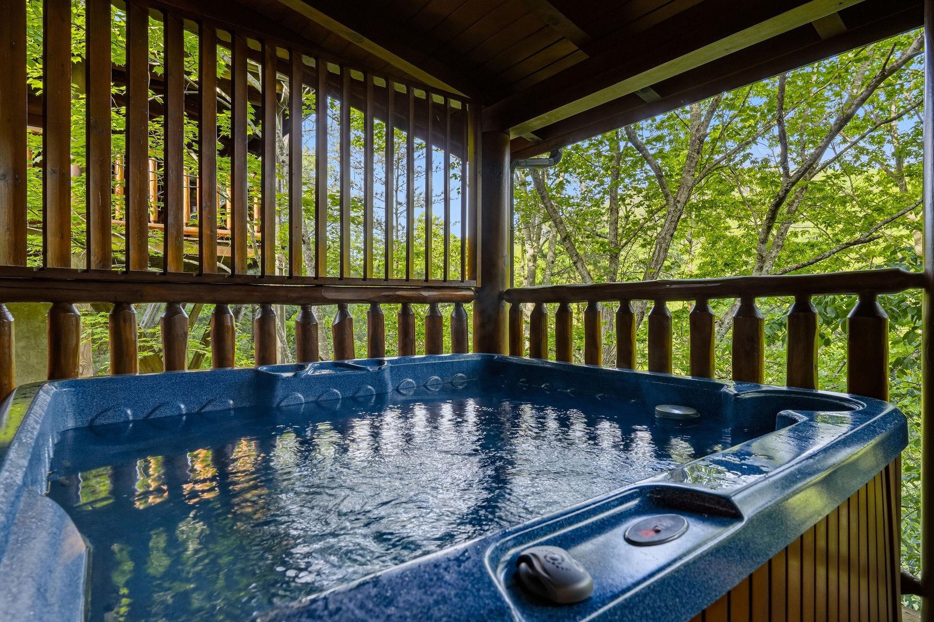 Soak in your private hot tub while surrounded by lush forest canopy, creating the perfect woodland retreat for ultimate relaxation.