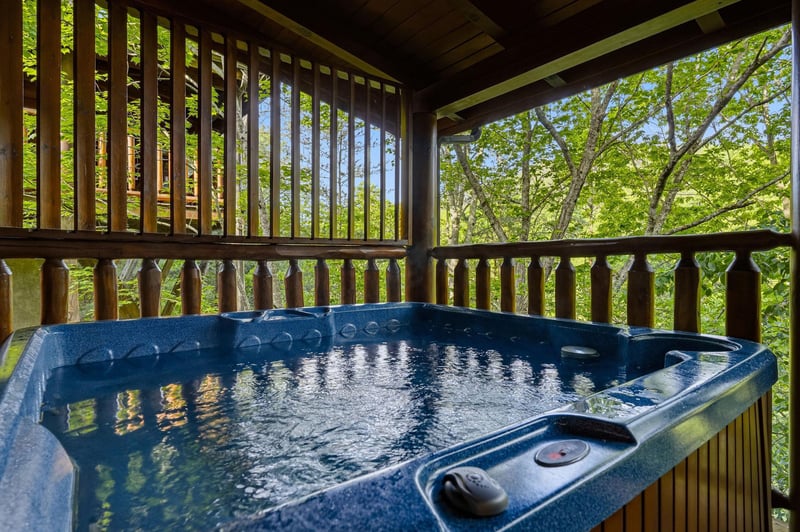 Soak in your private hot tub while surrounded by lush forest canopy, creating the perfect woodland retreat for ultimate relaxation.