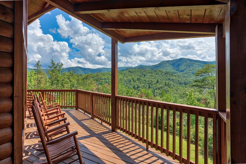 Rocking chairs on the covered deck with mountain views at Four Seasons Lodge, a 3bedroom cabin rental located in Pigeon Forge