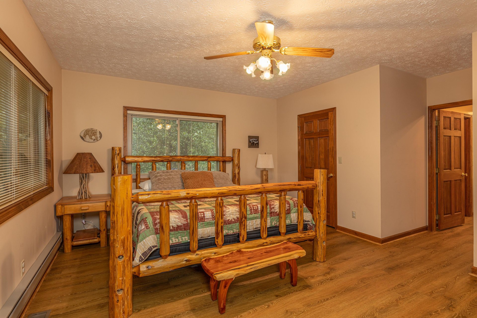 Bedroom with a log bed, two night stands, and a bench at Cubs Crib, a 3 bedroom cabin rental located in Gatlinburg