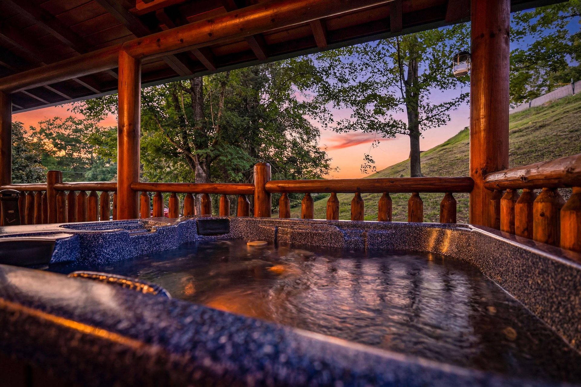 Soak in your private hot tub under a stunning sunset, surrounded by peaceful mountain views and fresh evening air.