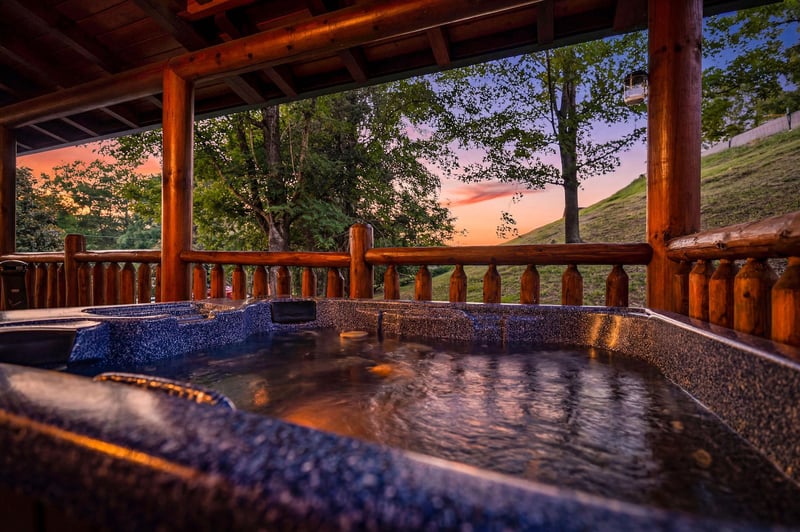 Soak in your private hot tub under a stunning sunset, surrounded by peaceful mountain views and fresh evening air.