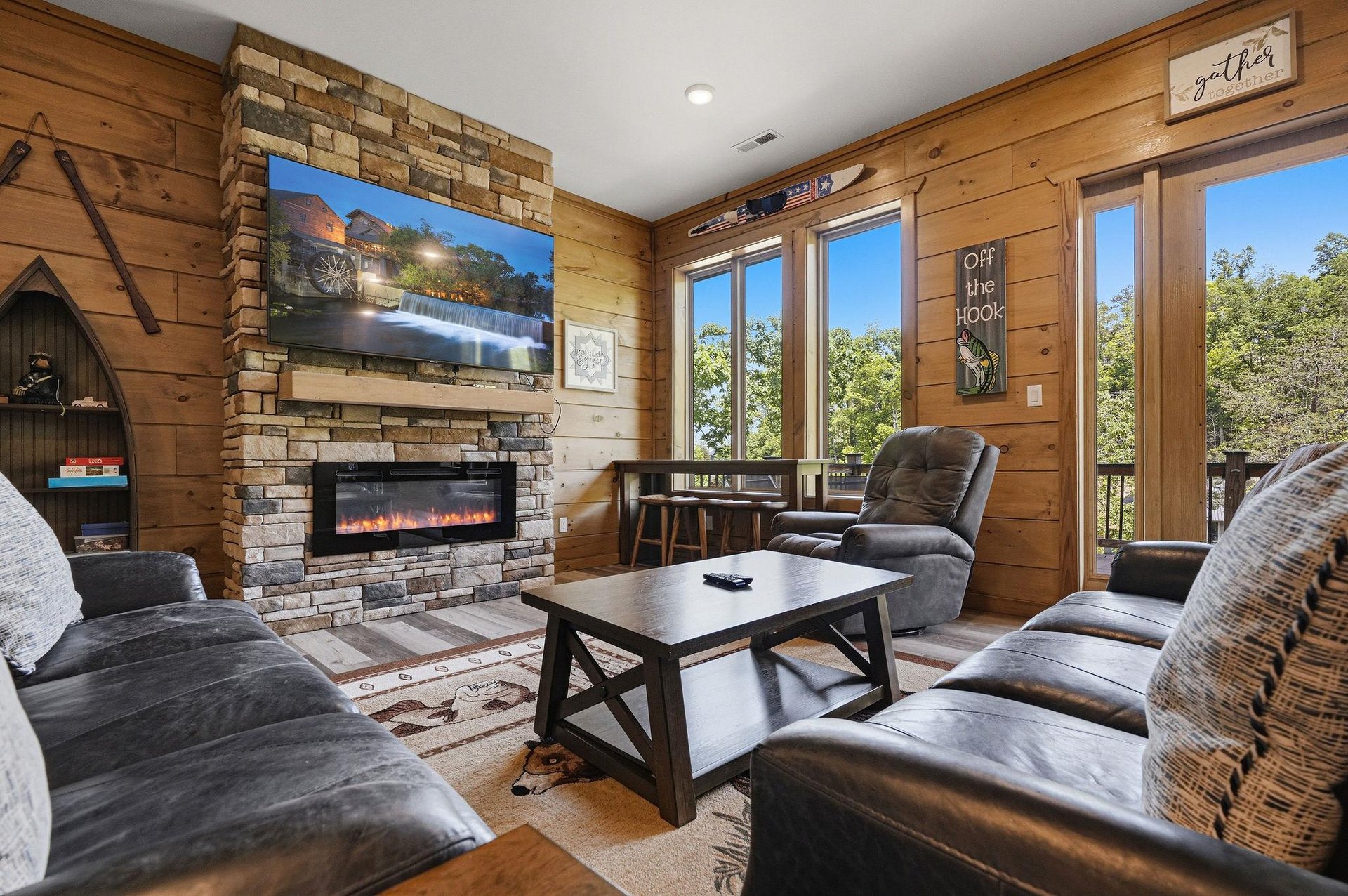 Sink into plush leather seating by your cozy fireplace, where rustic charm meets modern comfort in this inviting living space.