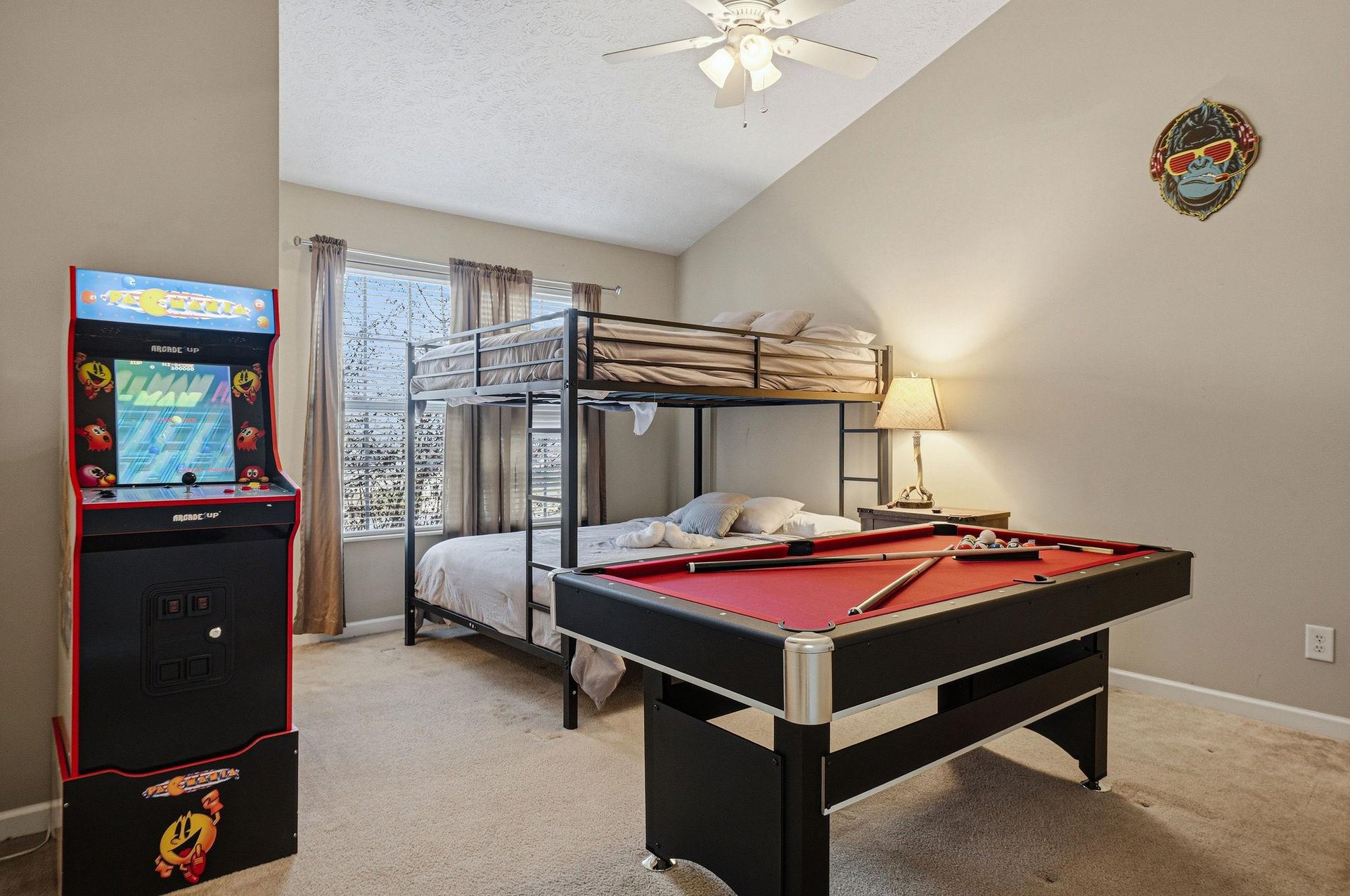 Your game room combines cozy sleeping with endless fun—bunk beds for rest, pool table and arcade for play