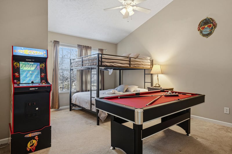Your game room combines cozy sleeping with endless fun—bunk beds for rest, pool table and arcade for play