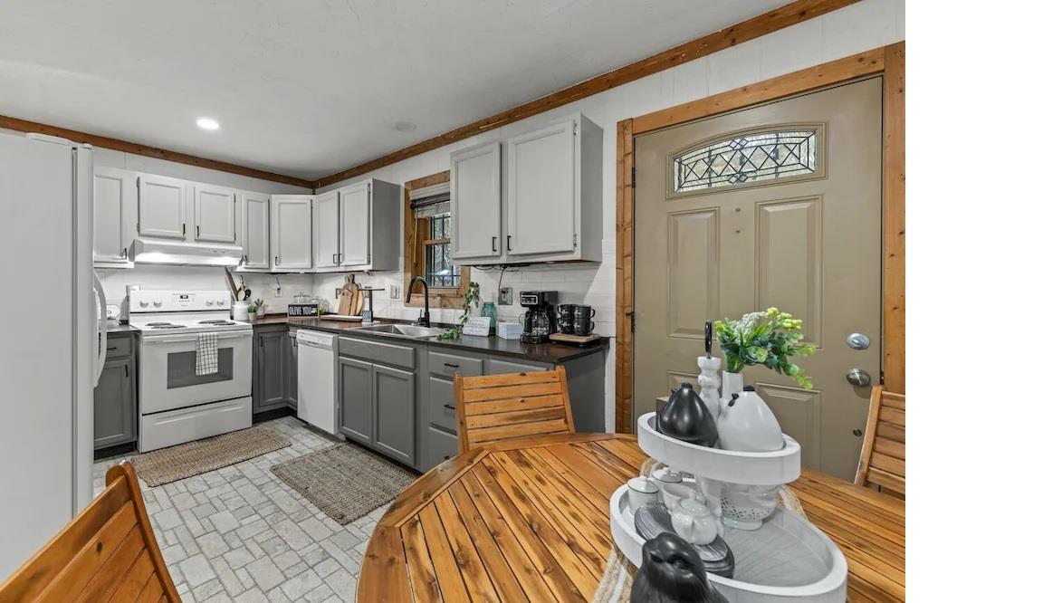 Your fully equipped kitchen features modern appliances and warm wood accents, perfect for preparing homecooked meals during your stay.