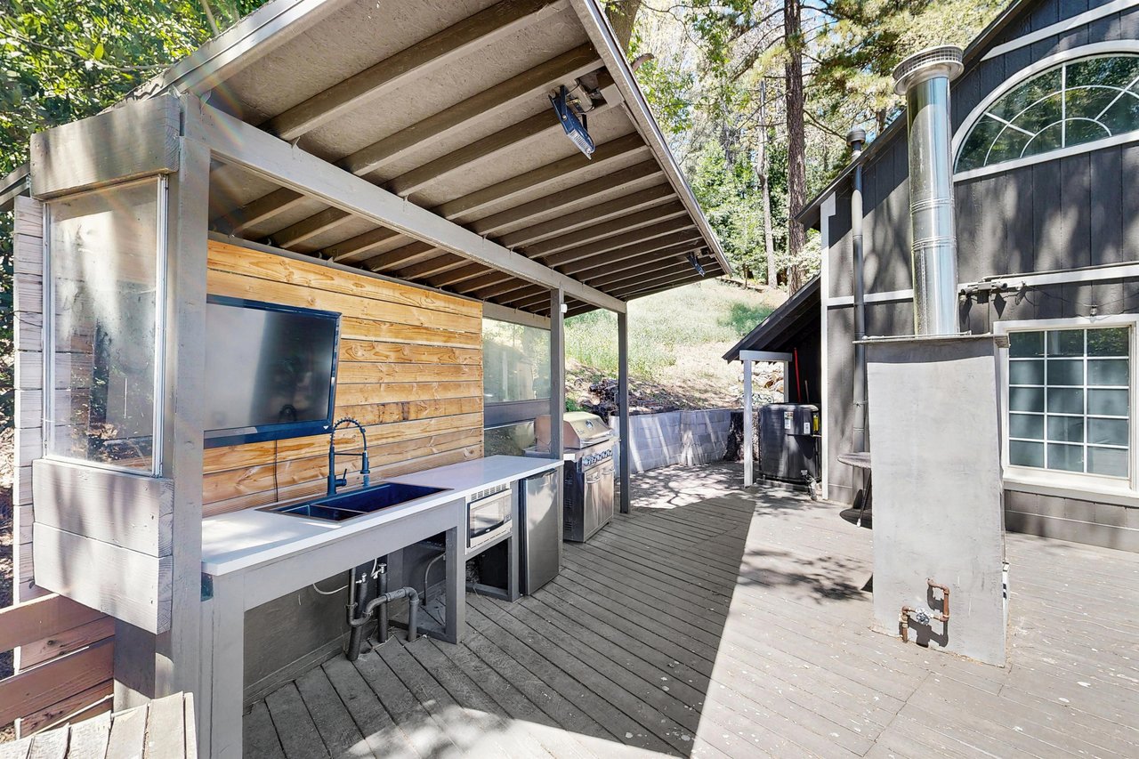 The deck area is perfect for entertaining with wet bar, outdoor seating, and an outdoor fireplace.