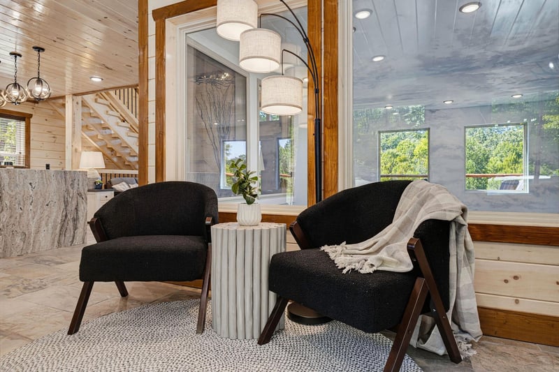 Sink into the soft embrace of midcentury chairs and let natural light stream in as you unwind with a good book or morning coffee in this cozy nook.