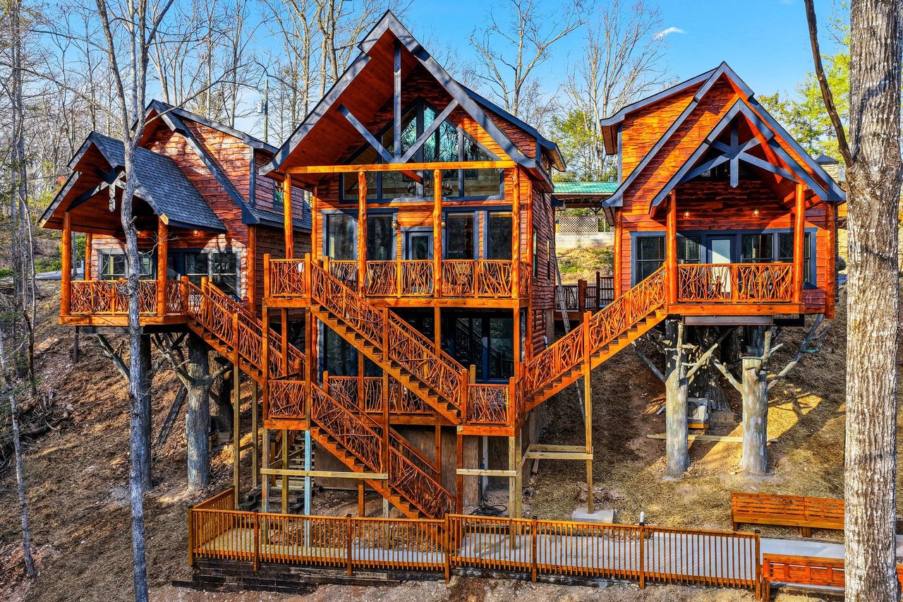 Stunning multilevel treehouse retreat with connecting bridges and decks, nestled among tall trees for an unforgettable forest escape.