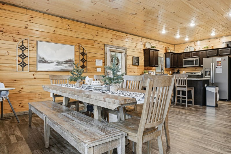 Gather around your rustic dining table where warm wood surrounds you and memories are made over shared meals in this cozy cabin retreat.