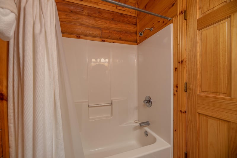 Bathroom with a tub and shower at Gone Fishin, a 2bedroom cabin rental located in Pigeon Forge