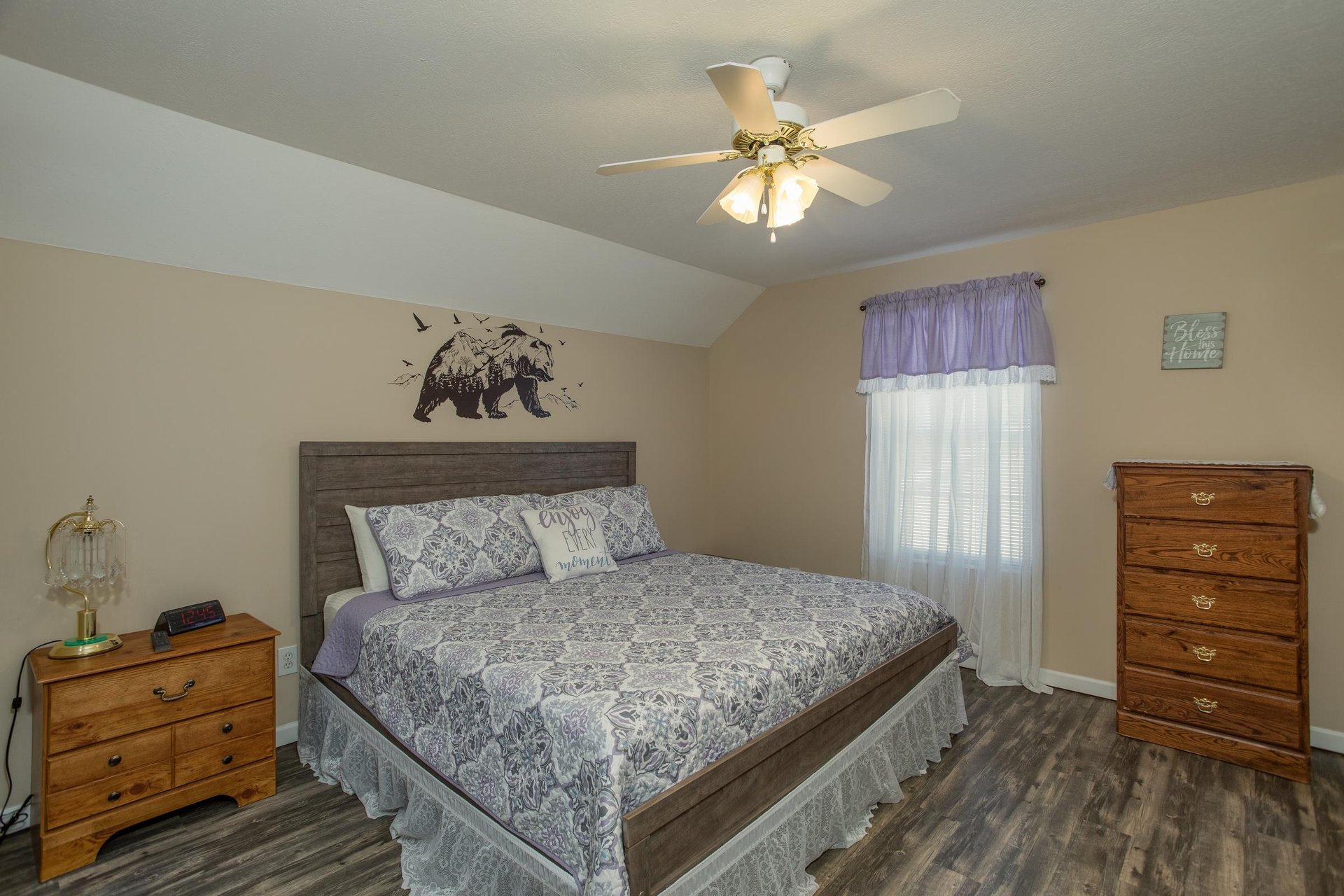 Bedroom with a king bed, dresser, and small dresser at Peace at the River, a 3 bedroom cabin rental located in Pigeon Forge