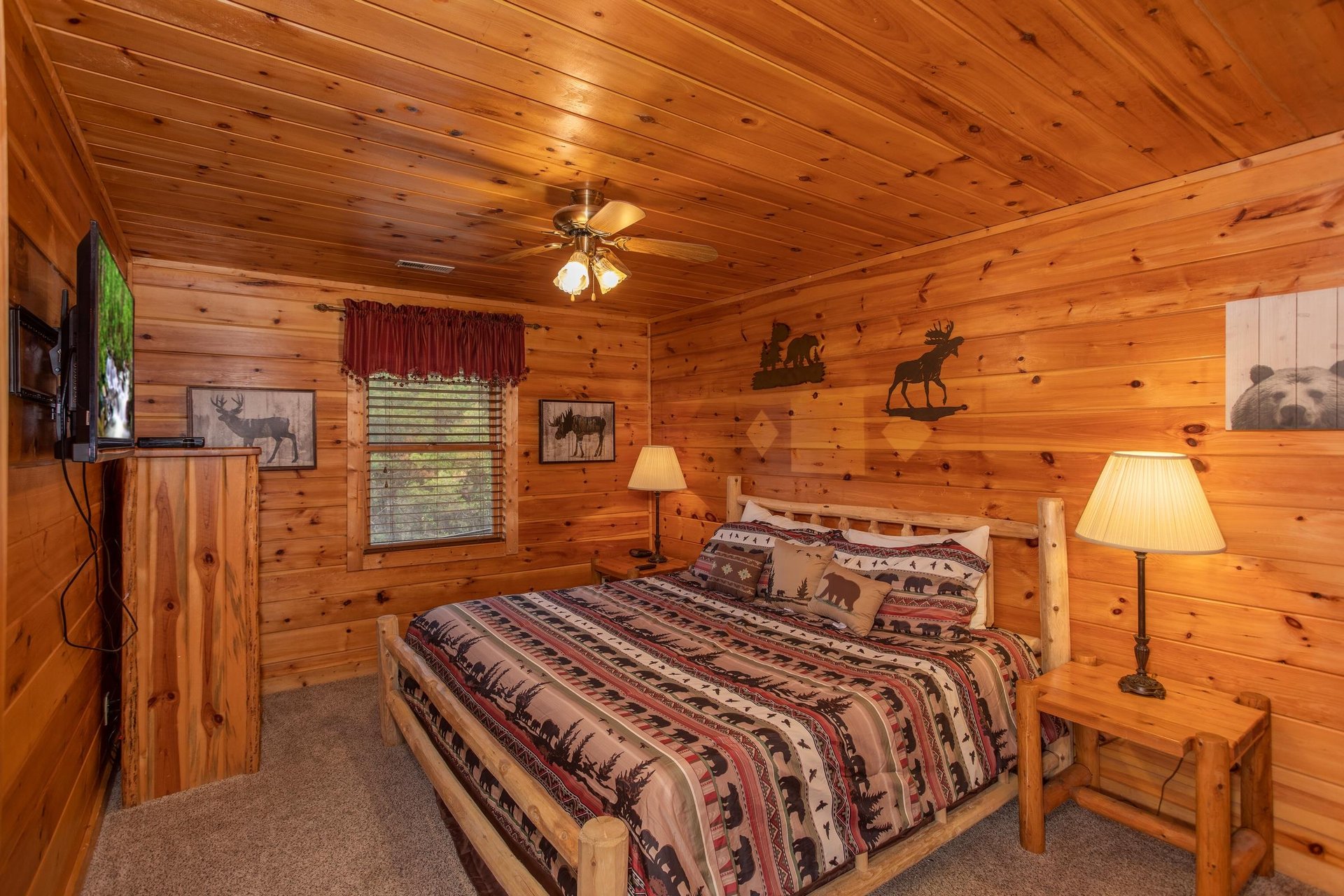 Bedroom with a kingsized log bed at Hibernation Station, a 3bedroom cabin rental located in Pigeon Forge