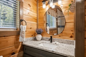 Refresh in your rusticchic bathroom with warm wood walls, granite counters, and thoughtful touches.