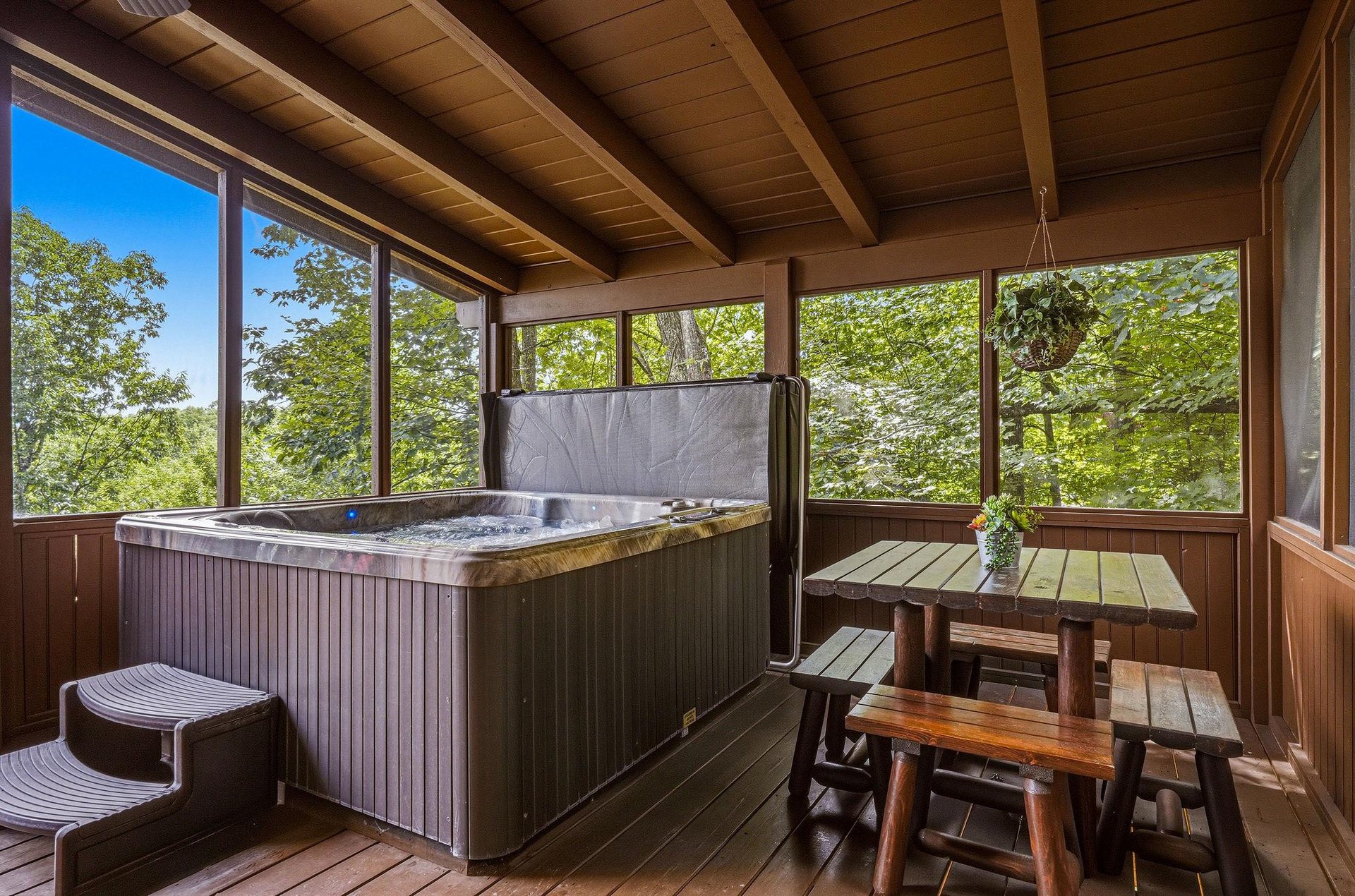 Soak your worries away in your private hot tub, tucked into a screened porch with sweeping forest views and cozy seating nearby.