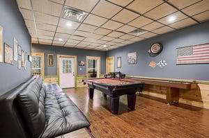 Challenge friends to pool while lounging on the leather sectional in your private game room retreat.
