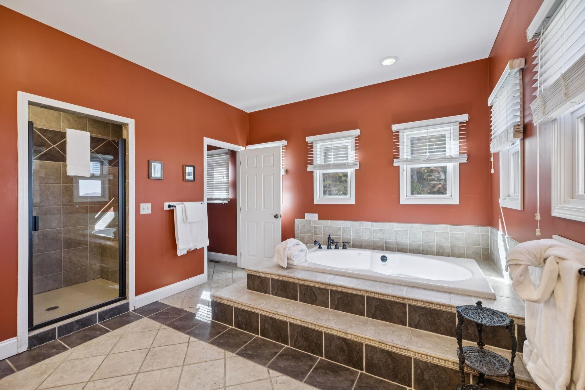 Unwind in your private spalike retreat with a spacious soaking tub and walkin shower—plush towels and warm earth tones create a serene escape.