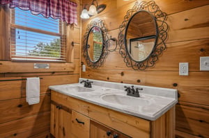 Step into your charming log cabin bathroom with rustic elegance and thoughtful touches that make you feel right at home. The warm wood walls and dual sinks offer plenty of space to refresh together.