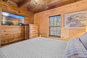 Queen bed with window and tv