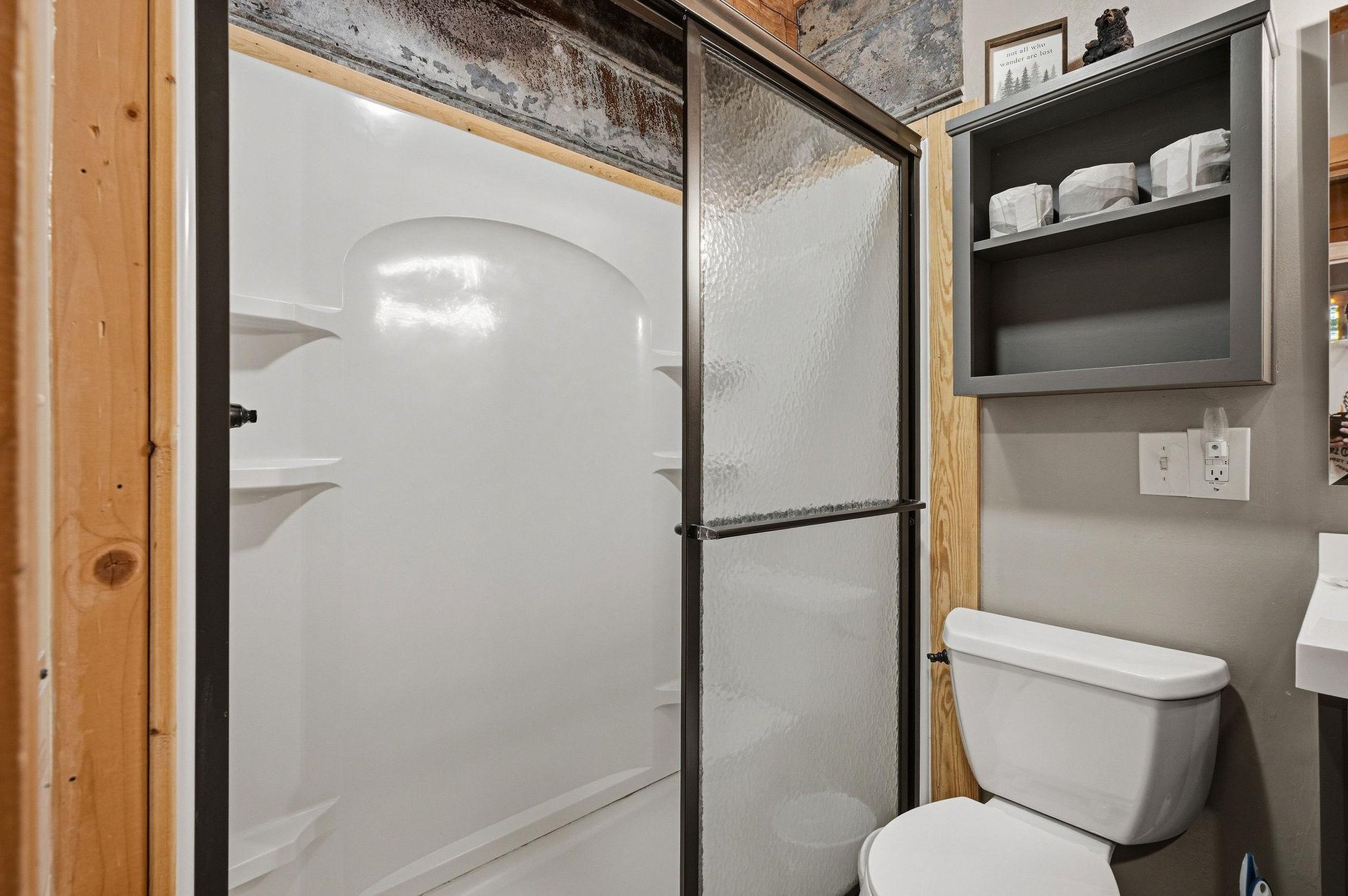 Your private bathroom features a spacious walkin shower with sleek glass doors, modern fixtures, and thoughtful storage—designed to keep you refreshed and comfortable throughout your stay.