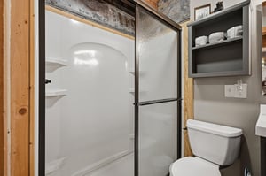 Your private bathroom features a spacious walkin shower with sleek glass doors, modern fixtures, and thoughtful storage—designed to keep you refreshed and comfortable throughout your stay.