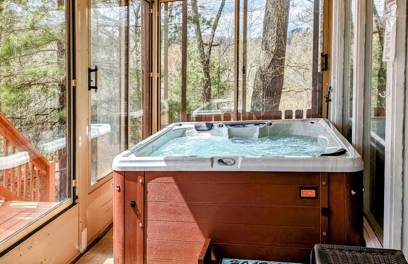 Hot tub on screened in porch at Buena Vista Getaway, 3 bedroom cabin rental located in Gatlinburg