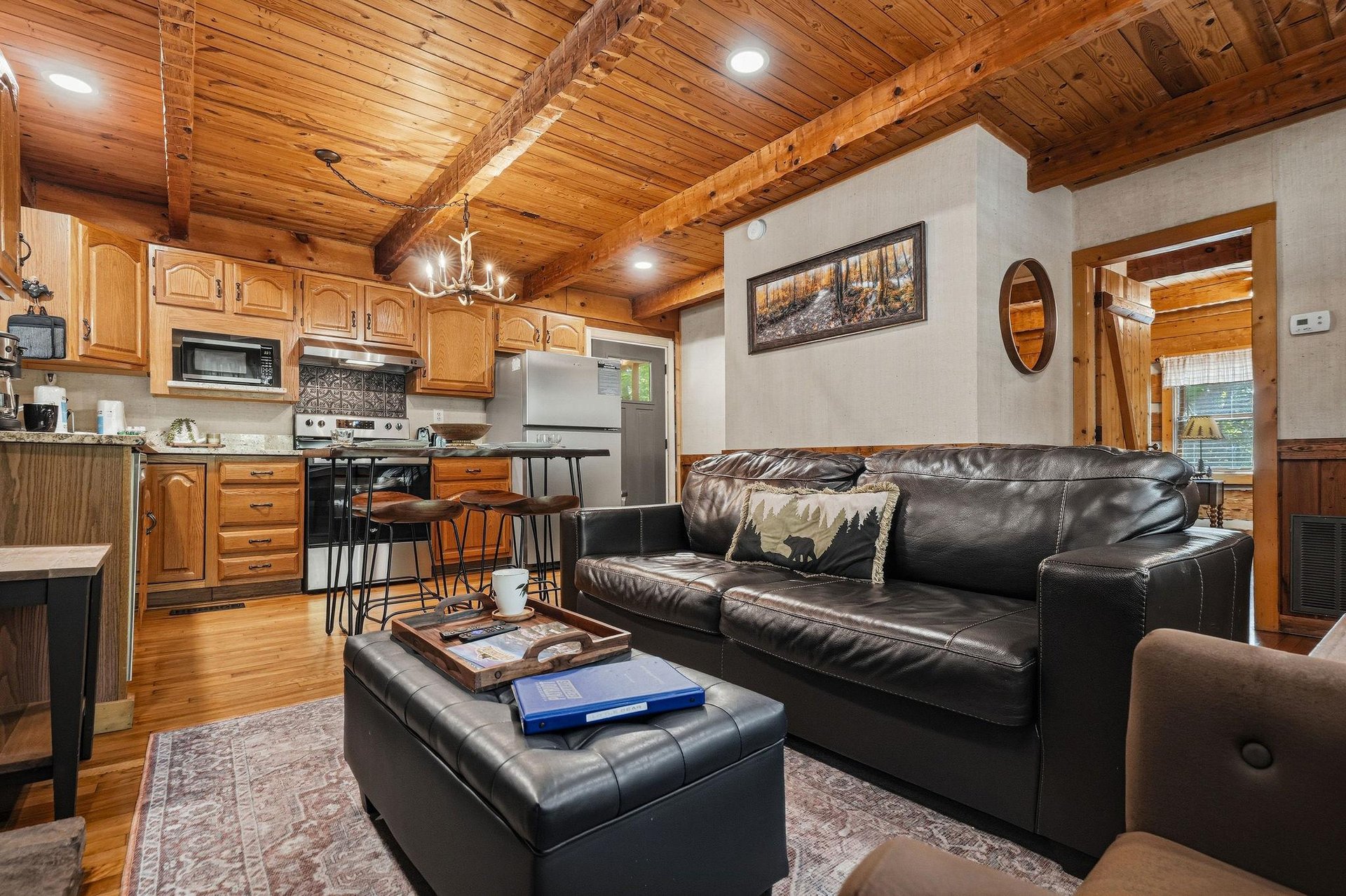 Cozy up in this inviting cabin space where rustic wood beams and warm lighting create the perfect mountain retreat for your getaway.