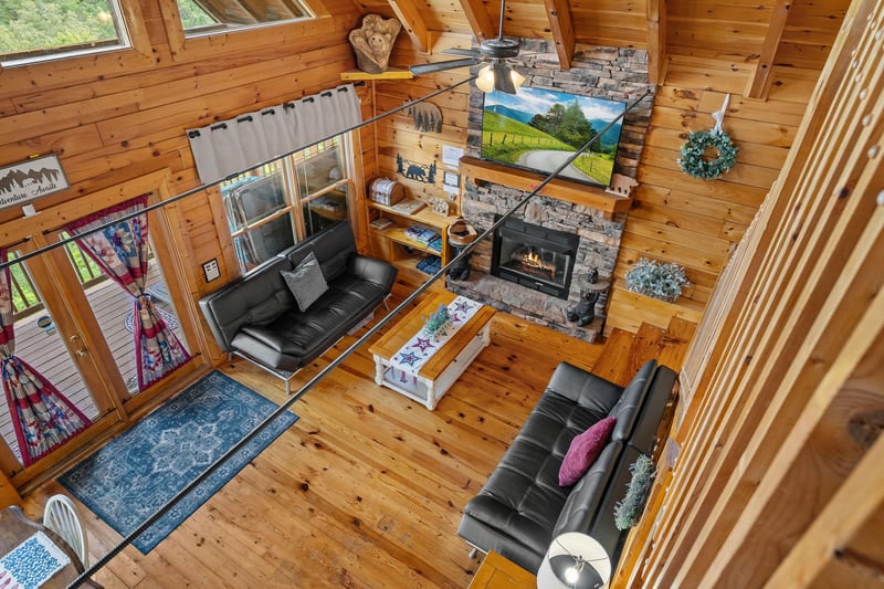 Living room with 2 futons and stone fireplace