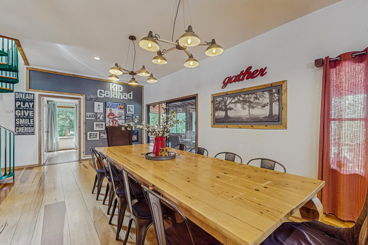 Right off the kitchen, this dining area seats the group beneath eyecatching sputnikstyle chandeliers, with the Kid Galahad memorabilia wall visible in the background — posters and mementos from Elviss 1962 film.
